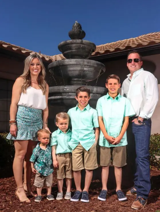 A family posing in front of a fountain.